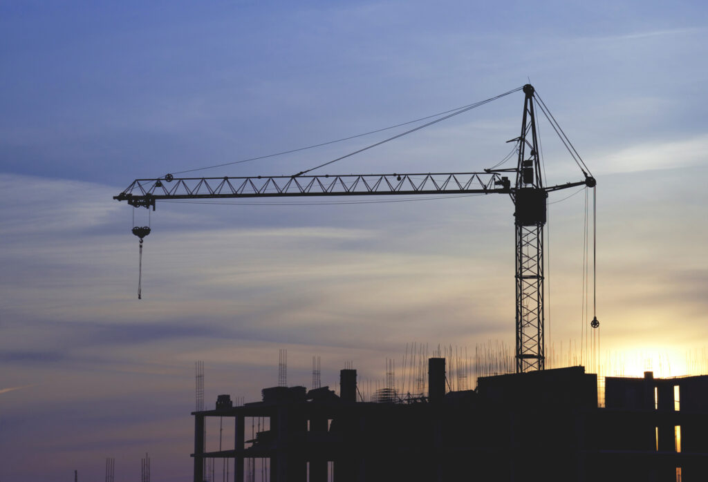 Silhouette of a construction crane at sunset
